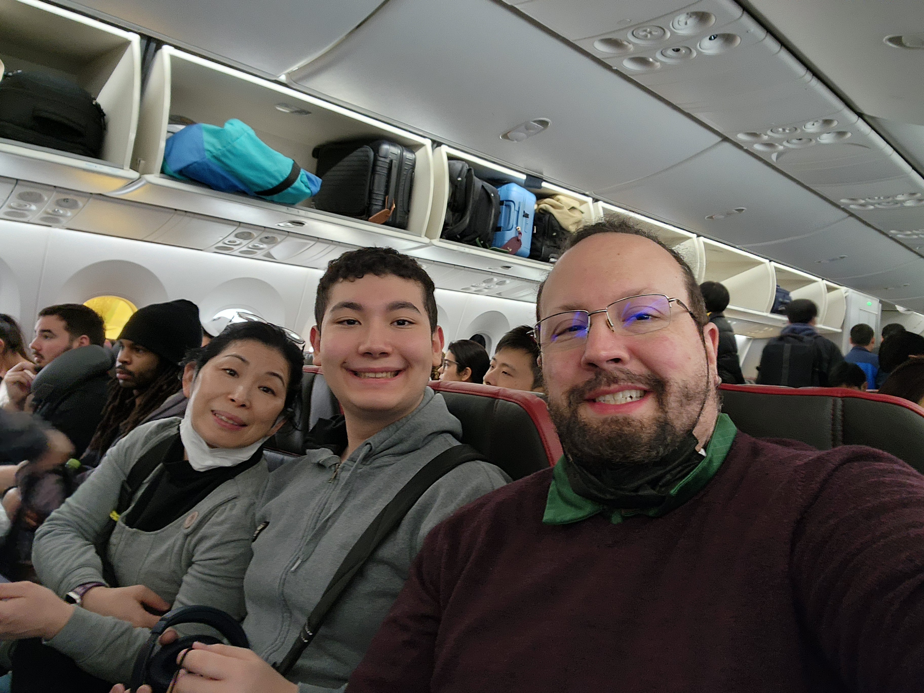 Salaka family on airplane -Stephen, wife, and son