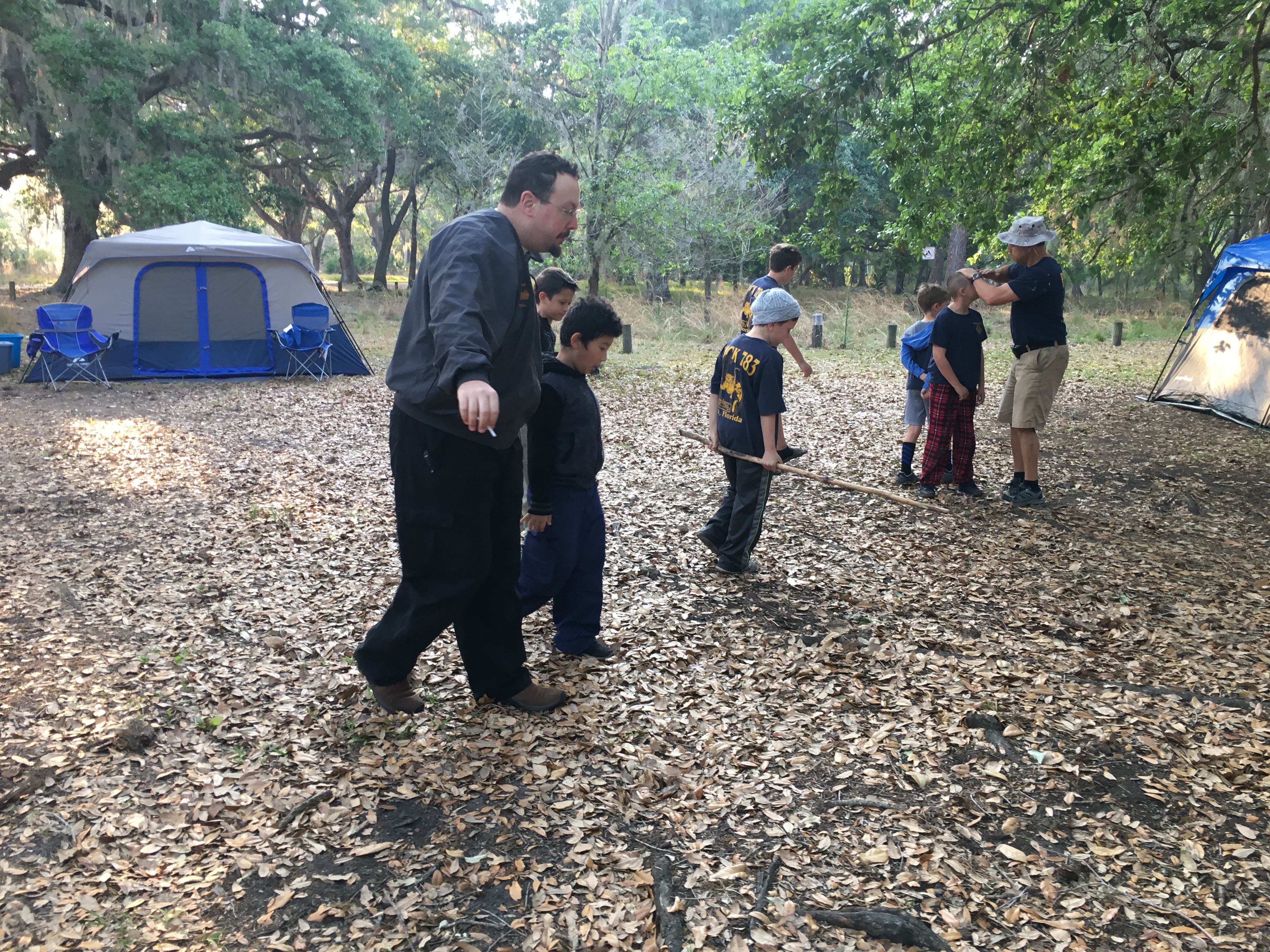 Stephen leading kids on scout campsite hike