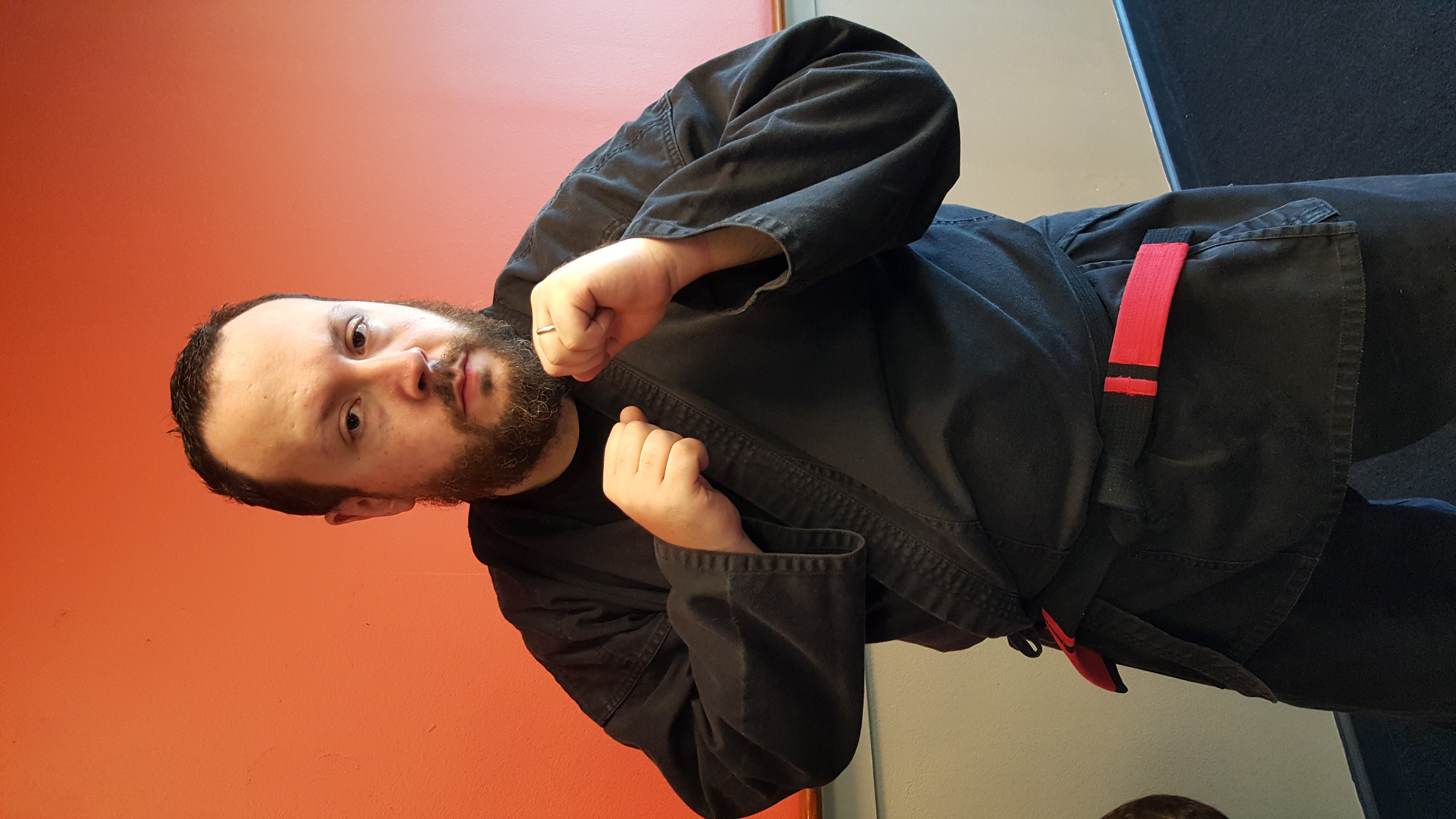 Stephen in black gi with red stripe, fighting stance